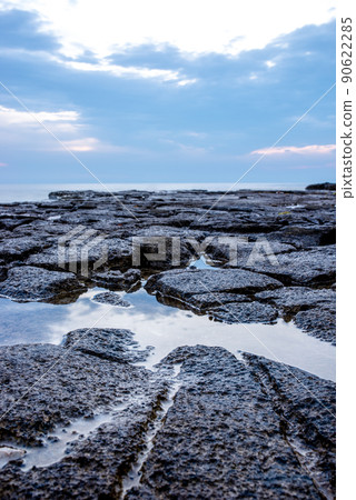 Tranquil rock pool on a rocky shoreline Tranquil rock pool on a rocky shoreline 90622285