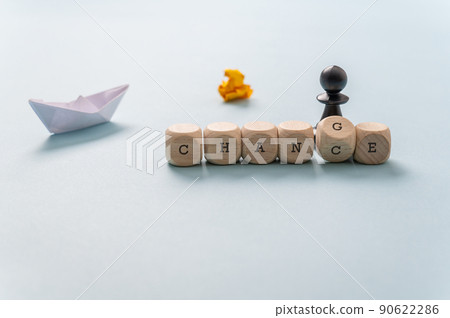 Chess figure next to a changing Chance - Change sign spelled on wooden dice Chess figure next to a changing Chance - Change sign spelled on wooden dice 90622286