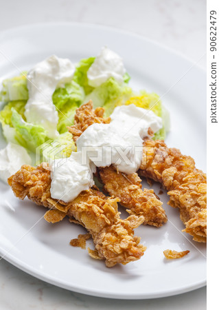 fried chicken in cornflakes with lettuce and garlic dip fried chicken in cornflakes with lettuce and garlic dip 90622479