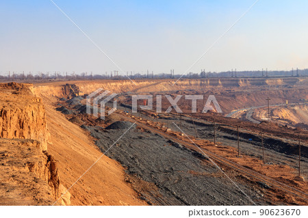Big yellow excavator working in iron ore quarry Big yellow excavator working in iron ore quarry 90623670