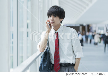 High school boys calling while commuting to school 90623872