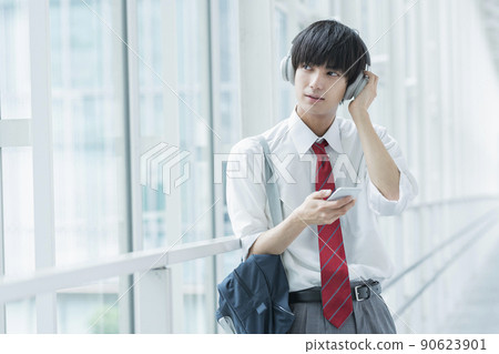 High school boy listening to music 90623901