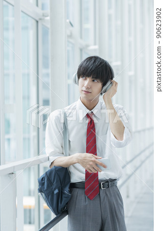 High school boy listening to music High school boy listening to music 90623902