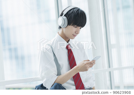 High school boy listening to music High school boy listening to music 90623908