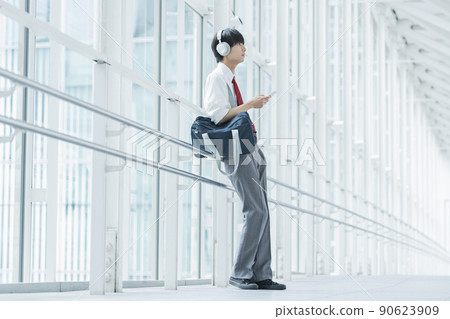 High school boy listening to music High school boy listening to music 90623909