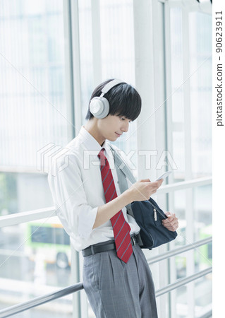 High school boy listening to music High school boy listening to music 90623911