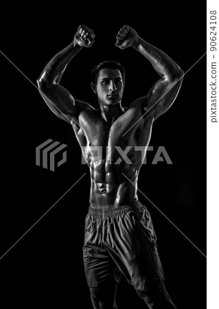 Muscular and fit young bodybuilder fitness male model posing ove Muscular and fit young bodybuilder fitness male model posing ove 90624108