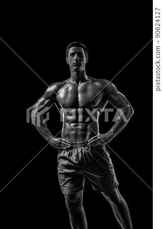 Muscular and fit young bodybuilder fitness male model posing ove 90624127