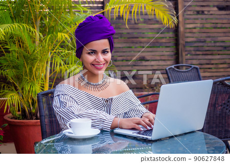 Beautiful mixed race woman remote working in the coffee shop summer cafe . indian female holding cup of tea . coffeebreak concept 90627848