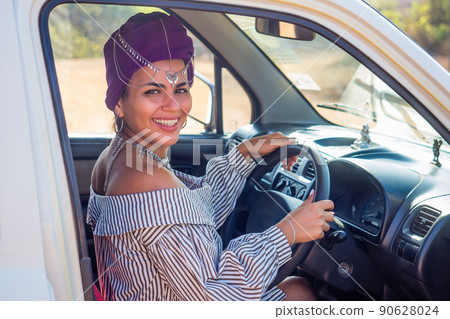 cheerful young african american woman in a purple turban on head showing her new car key at summer beach.indian female person enjoying a new car purchase cheerful young african american woman in a purple turban on head showing her new car key at summer beach.indian female person enjoying a new car purchase 90628024