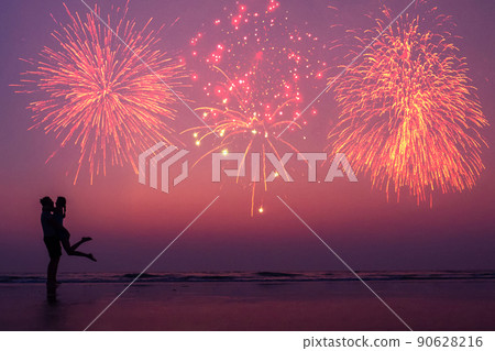 happy couple on the beach enjoying the sunset: concept of independence of america and valentines day 90628216