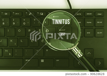 Hand writing sign Tinnitus. Internet Concept A ringing or music and similar sensation of sound in ears Computer Keyboard And Symbol.Information Medium For Communication. 90628628