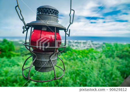 Old lamp oil lantern camping equipment rugged equipment sea and sky hill copy space 90629812