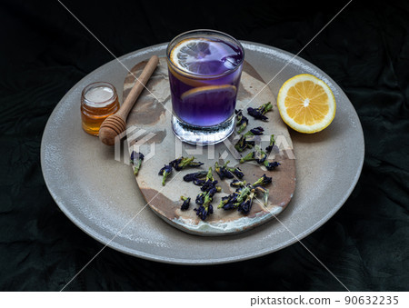 Blue and violet color butterfly peaflower juice (Clitoria) mixed with lemonade served with honey. 90632235