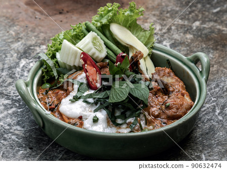 Traditional stir fried spicy Asian Redtail Catfish (Hemibagrus wyckioides) or Kang catfish with red curry paste. 90632474