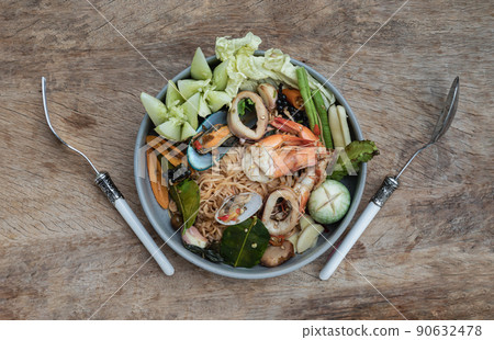 Spicy Stir Fried seafood Instant Noodles with herbs with various spices served with vegetables in ceramic plate. Spicy Stir Fried seafood Instant Noodles with herbs with various spices served with vegetables in ceramic plate. 90632478