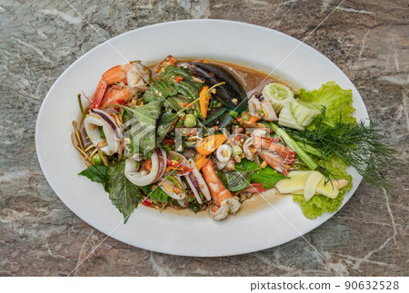 Stir-Fried Spicy seafood with herbs and spices served on white plate. Authentic thai food. Stir-Fried Spicy seafood with herbs and spices served on white plate. Authentic thai food. 90632528