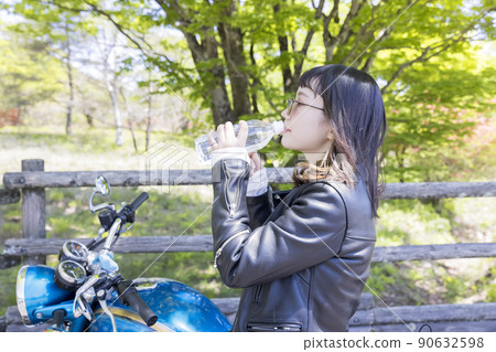 Bike girl image Young woman hydrating during touring 90632598