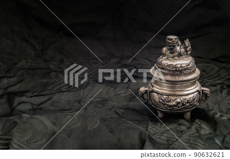 engraved decorate on Small silver ancient incense burner on dark background. engraved decorate on Small silver ancient incense burner on dark background. 90632621