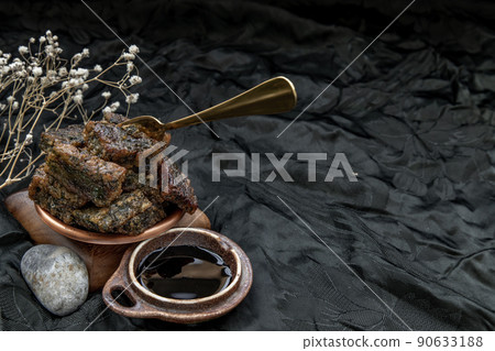 Crispy Fried Kuicheai Served with Sweet Black Soy Sauce on wooden plate in dark background. 90633188