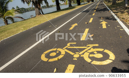 Road for Cyclists with blue sky background,and a large pond. Road for Cyclists with blue sky background,and a large pond. 90633955