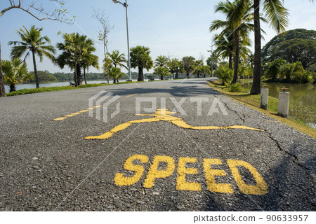 Road for runners with blue sky background,and a large pond. 90633957