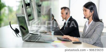 Business people wearing headset working in office broaden view Business people wearing headset working in office broaden view 90635633