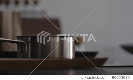 Steam rising from saucepan with boiling water on kitchen 90635683
