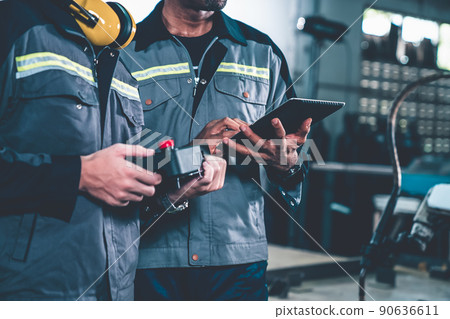 Group of factory job workers using adept machine equipment in a workshop 90636611