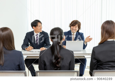 A businessman in a suit interviewing 90640289