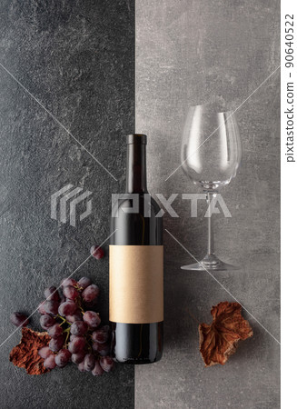 Red wine with grapes on a stone background. Red wine with grapes on a stone background. 90640522