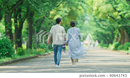 A couple taking a walk in the park in early summer 90641743