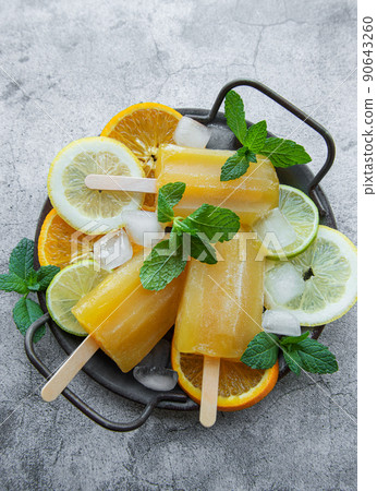 Natural juicy orange popsicles. Natural juicy orange popsicles. 90643260
