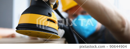 Man carpenter work with professional sander machine on flat project Man carpenter work with professional sander machine on flat project 90644904