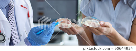 Professional doctor explain difference between breast implants to client Professional doctor explain difference between breast implants to client 90644934