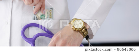 Doctor carry stethoscope tool and show piece of banknote in pocket Doctor carry stethoscope tool and show piece of banknote in pocket 90645006