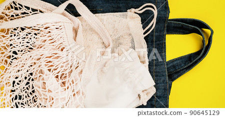 Eco Bags.Sustainable lifestyle.A variety of eco bags on a yellow background . Zero waste minimal composition with tring and canvas bags for storage.Zero waste, eco friendly shopping.Top view,flat lay. Eco Bags.Sustainable lifestyle.A variety of eco bags on a yellow background . Zero waste minimal composition with tring and canvas bags for storage.Zero waste, eco friendly shopping.Top view,flat lay. 90645129