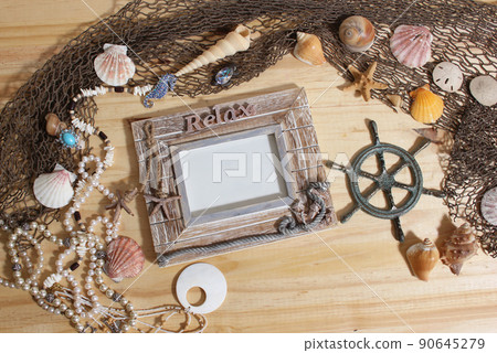 Empty Frame on Wooden Background With Sea Shells and Fishing Net. Nautical and Coastal Theme Empty Frame on Wooden Background With Sea Shells and Fishing Net. Nautical and Coastal Theme 90645279