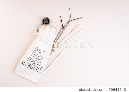 Zero waste and eco friendly,plastic free concept.Reusable glass bottle on white background.Cotton bag,glass bottle and metal reusable and paper disposable tubes.Copy space.Ecological,natural materials Zero waste and eco friendly,plastic free concept.Reusable glass bottle on white background.Cotton bag,glass bottle and metal reusable and paper disposable tubes.Copy space.Ecological,natural materials 90645340