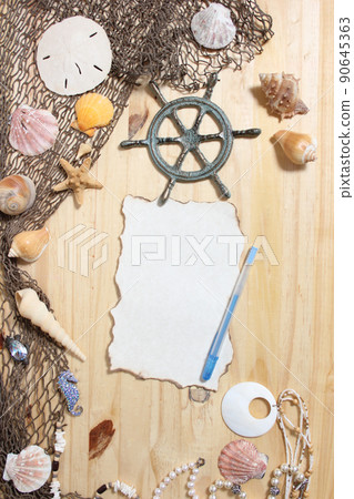 Blank Paper With Burned Edges on Wooden Background With Sea Shells and Fishing Net. Nautical and Coastal Theme Blank Paper With Burned Edges on Wooden Background With Sea Shells and Fishing Net. Nautical and Coastal Theme 90645363