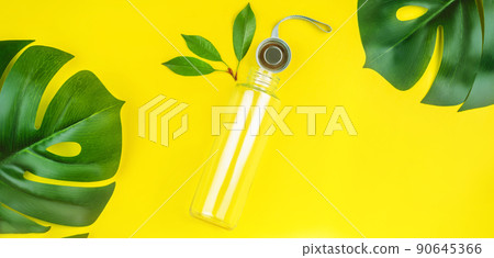 Banner,poster.Reusable glass bottle for water on yellow background.May bottle.Let's go shopping.Ecological, natural materials.The concept zero waste.The view from the top.Life without Plastic. Banner,poster.Reusable glass bottle for water on yellow background.May bottle.Let's go shopping.Ecological, natural materials.The concept zero waste.The view from the top.Life without Plastic. 90645366