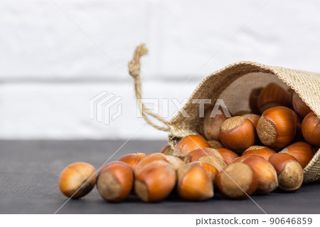 close up of hazelnuts on wooden table 90646859