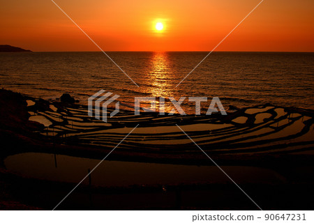 Oku Noto, Shiroyone Senmaida before rice planting, beautiful sunset scenery that dyes the sea and rice terraces in orange, no people Oku Noto, Shiroyone Senmaida before rice planting, beautiful sunset scenery that dyes the sea and rice terraces in orange, no people 90647231