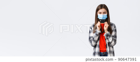 Coronavirus outbreak, working from home, online shopping and contactless payment concept. Girl in medical mask smiling sly and showing credit card, ready waste all money in internet stores Coronavirus outbreak, working from home, online shopping and contactless payment concept. Girl in medical mask smiling sly and showing credit card, ready waste all money in internet stores 90647391