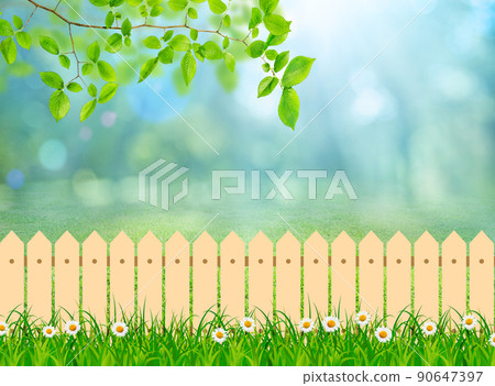 a Green field landscape from backyard with daisy flowers and wooden picket fence 90647397
