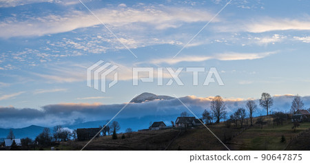 Picturesque pre sunrise morning above late autumn mountain countryside. Ukraine, Carpathian Mountains, Petros top in far. Peaceful traveling, seasonal, nature and countryside beauty concept scene. Picturesque pre sunrise morning above late autumn mountain countryside. Ukraine, Carpathian Mountains, Petros top in far. Peaceful traveling, seasonal, nature and countryside beauty concept scene. 90647875