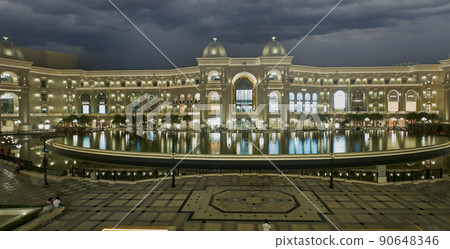 Place Vendome Mall  in Lusail city, Qatar interior view at night showing the architecture of the mall with big fountain in foreground 90648346