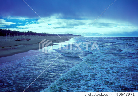 Sea shore in stormy weather. Beautiful dramatic sky over beach. 90648971