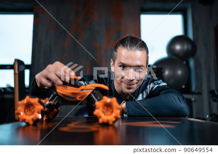 young man play with toy car and expressing inner child young man play with toy car and expressing inner child 90649554