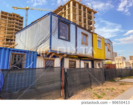 house for poor people. construction of new housing, temporary residential buildings. houses for builders from wagons with windows in two rows 90650413